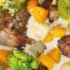 A picture of Chicken smothered in mushroom sauce with veggies.