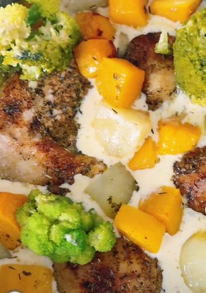 A picture of Chicken smothered in mushroom sauce with veggies.