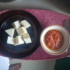 A picture of Boiled yam with tomato sauce.