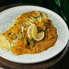 A picture of Butter Noodles with Chicken Strips Curry.