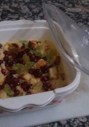 A picture of Custard with fruits and dry fruits.
