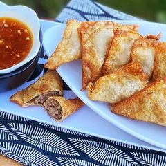 A picture of Fried Wagyu Beef Wontons with Duck Sauce.