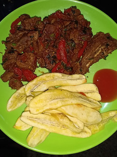 A picture of Wet fry pork and banana fries.