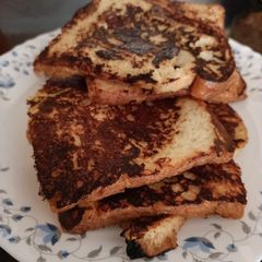 A picture of French toast with milk.