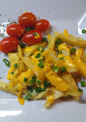 Una foto de Papas al horno con cheddar y verdeo