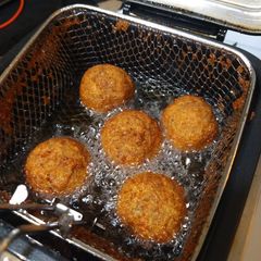 A picture of Deep fried Italian meatballs stuffed with cheese curds.