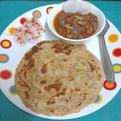 A picture of Chole With Chur - Chur Paratha (Flaky Indian Flat Bread).