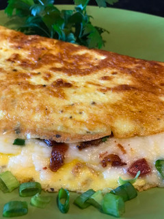 A picture of Omelette with Crispy Bacon, Vegetables and Mozzarella Cheese.