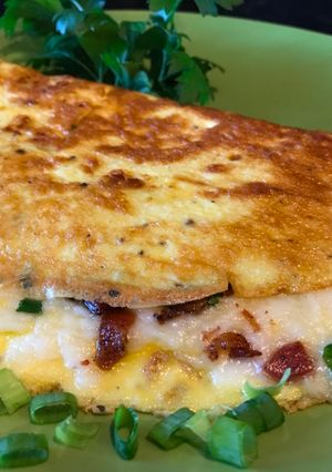 A picture of Omelette with Crispy Bacon, Vegetables and Mozzarella Cheese.