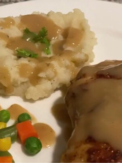 A picture of Pan fried chicken with mashed potatoes and Gravy.