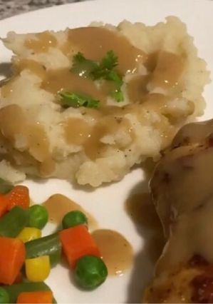 A picture of Pan fried chicken with mashed potatoes and Gravy.