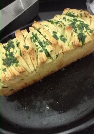 Una foto de Pan "en fetas" saborizado con queso, manteca y perejil