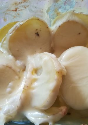 Una foto de Patatas al horno con crema y queso