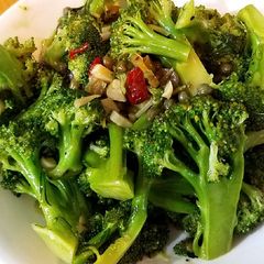 Steamed broccoli with chili and olive sauce A picture of Steamed broccoli with chili and olive sauce.