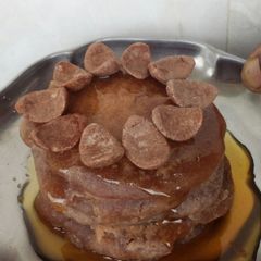 A picture of Oven Mini pancakes with honey and choco on top.