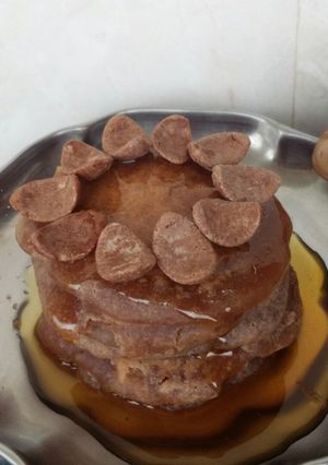 A picture of Oven Mini pancakes with honey and choco on top.