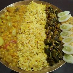 A picture of Veg thali..khichidi, dalma, okar fry, salad, papad.