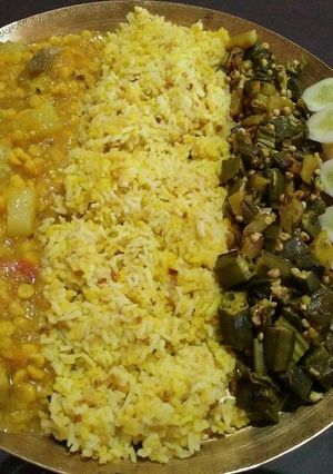 A picture of Veg thali..khichidi, dalma, okar fry, salad, papad.