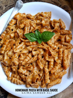 A picture of Homemade pasta with basil sauce.