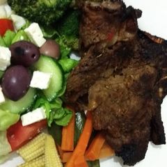 A picture of Shisanyama meat with healthy cooked vegetables.
