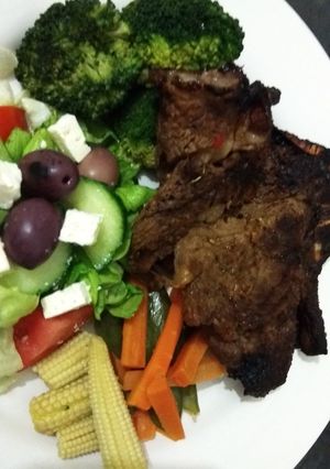 A picture of Shisanyama meat with healthy cooked vegetables.