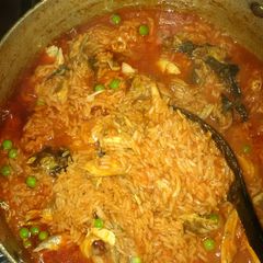 Jollof rice with green peas and smoked fish A picture of Jollof rice with green peas and smoked fish.
