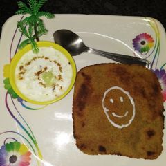 A picture of Oats paratha with cucumber raita.