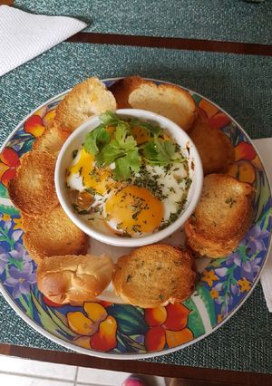 A picture of Baked Eggs with Sofrito and Oven-Roasted Turkey Ham.