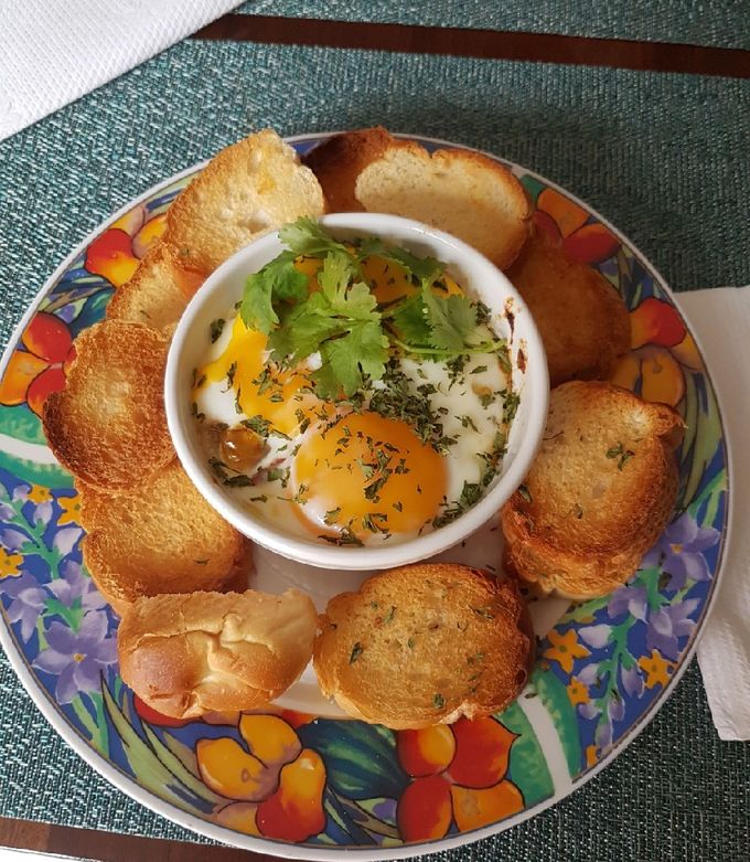 A picture of Baked Eggs with Sofrito and Oven-Roasted Turkey Ham.