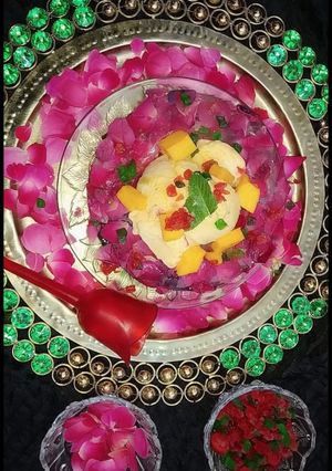 A picture of Mango tutti frutti ice cream in rose petals icebowl.