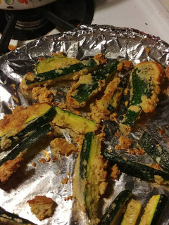 A picture of Parmesan zucchini fries with spicy appetizer dipping sauce.