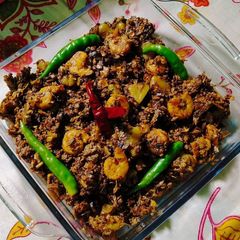 A picture of Banana Blossoms Curry With Prawns/Chingri Mach diye Mochar Ghonto.