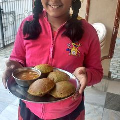 A picture of Methi kachori and aloo jhol.