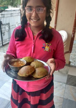 A picture of Methi kachori and aloo jhol.
