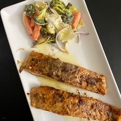 Salmon in lemon butter sauce with baked veggies A picture of Salmon in lemon butter sauce with baked veggies.