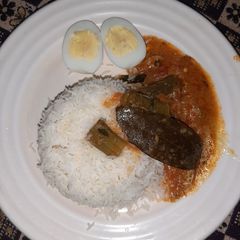 A picture of Bhindi ki kadhi with boil egg plain rice.