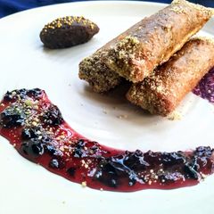A picture of Znoud-el-sit with creamy choco hummus filling and red grape sauce.