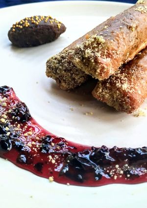 A picture of Znoud-el-sit with creamy choco hummus filling and red grape sauce.