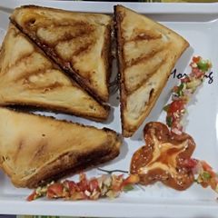 A picture of Schezwan Veg grilled sandwich.