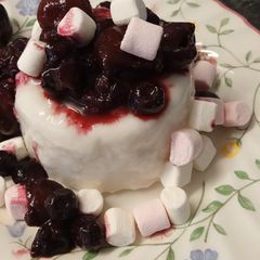 A picture of Boozy coconut Panna Cotta with cherries and blueberries #GoldenApron23.