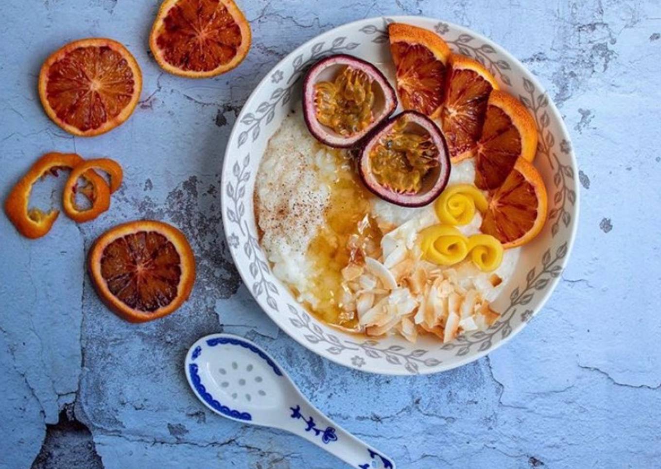 Rice porridge with almond milk, roasted coconut flakes, ground cinnamon, honey and mixed fruits