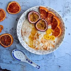 Rice porridge with almond milk, roasted coconut flakes, ground cinnamon, honey and mixed fruits A picture of Rice porridge with almond milk, roasted coconut flakes, ground cinnamon, honey and mixed fruits.