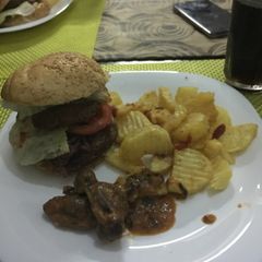 A picture of Potato wedges,wet fried gizzards and burger.