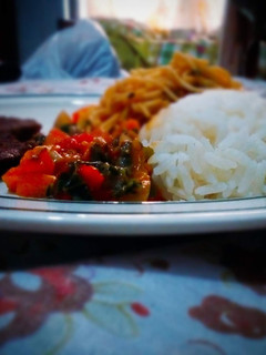 A picture of White rice and spaghetti with fried beef and vegetable sauce.