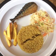 A picture of Jollof rice,salad with chips and fish.