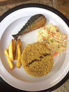 A picture of Jollof rice,salad with chips and fish.