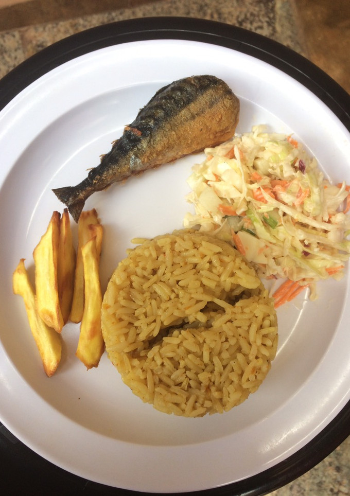 A picture of Jollof rice,salad with chips and fish.