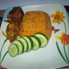 Jollof rice and Turkey with cucumber A picture of Jollof rice and Turkey with cucumber.