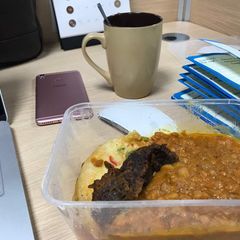 A picture of Porriage Beans with fried egg and beef.