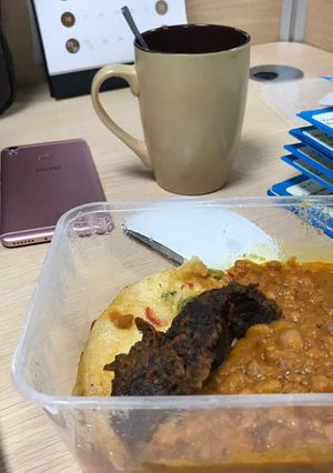 A picture of Porriage Beans with fried egg and beef.